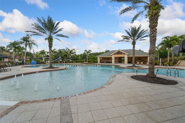 view of swimming pool with a patio area and pool water feature