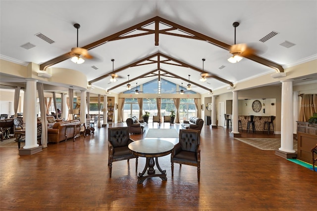 interior space with decorative columns, dark hardwood / wood-style floors, ceiling fan, and beam ceiling