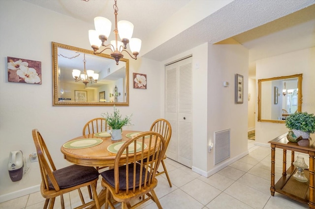 dining room featuring an inviting chandelier and light tile patterned flooring