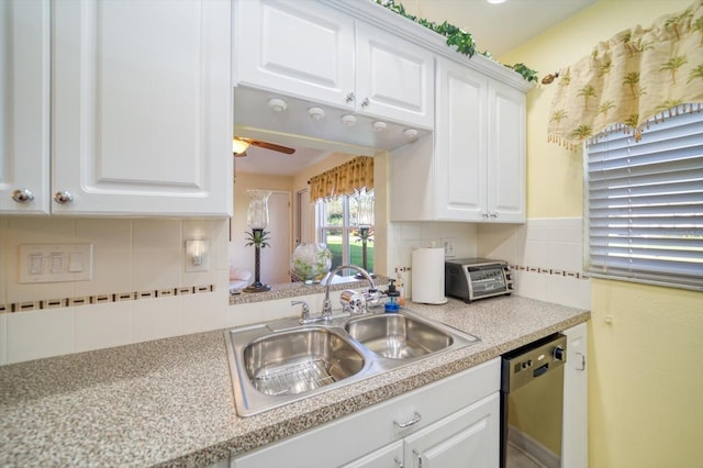 kitchen featuring dishwasher, white cabinetry, sink, decorative backsplash, and ceiling fan