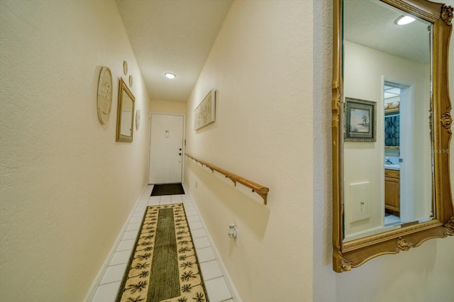 hall featuring light tile patterned flooring