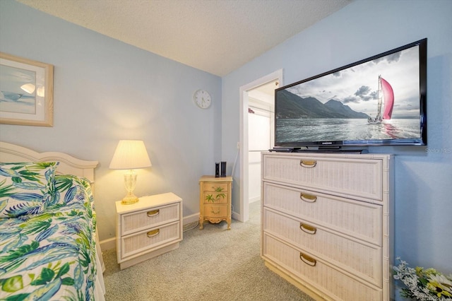 carpeted bedroom featuring a textured ceiling