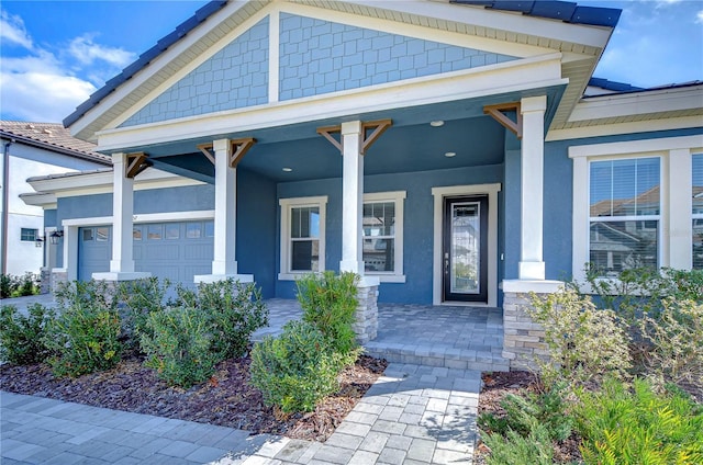 view of exterior entry with a porch