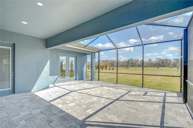 unfurnished sunroom featuring french doors