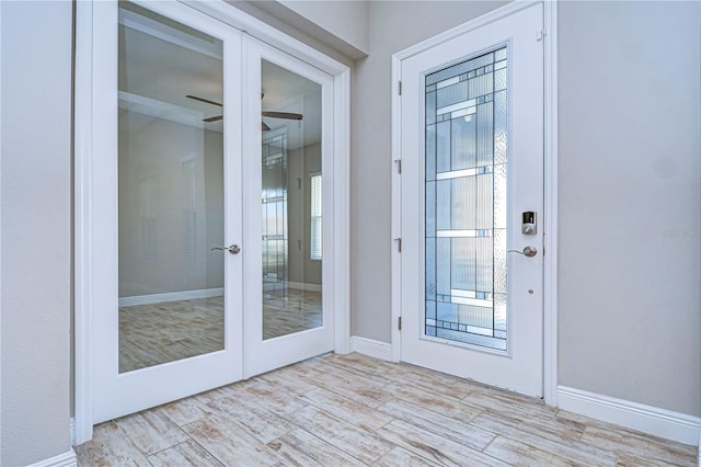 entryway with light hardwood / wood-style flooring, french doors, and ceiling fan