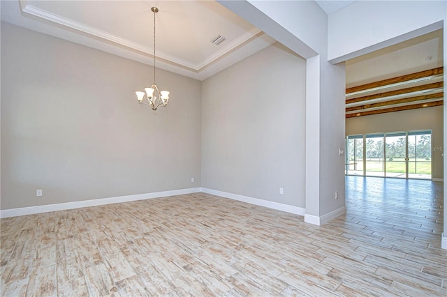 unfurnished room with light hardwood / wood-style flooring and a notable chandelier