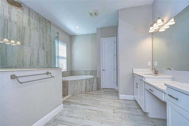 bathroom with vanity and separate shower and tub