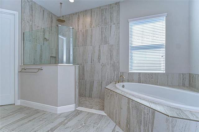 bathroom featuring separate shower and tub