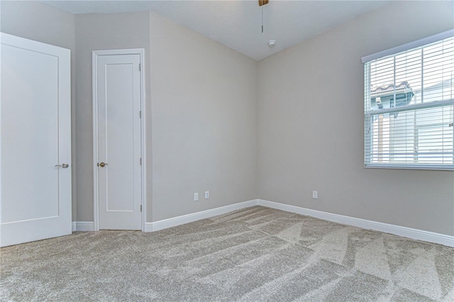 carpeted empty room with ceiling fan