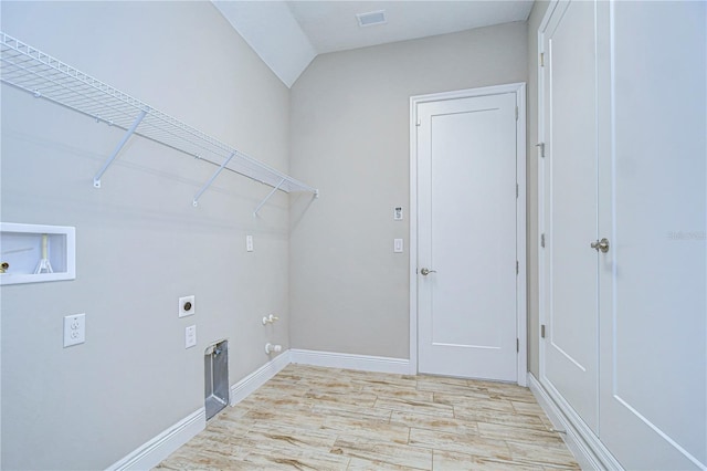 laundry area featuring hookup for a washing machine, gas dryer hookup, hookup for an electric dryer, and light hardwood / wood-style flooring