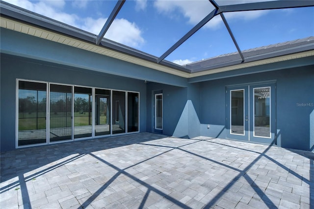 view of patio with glass enclosure