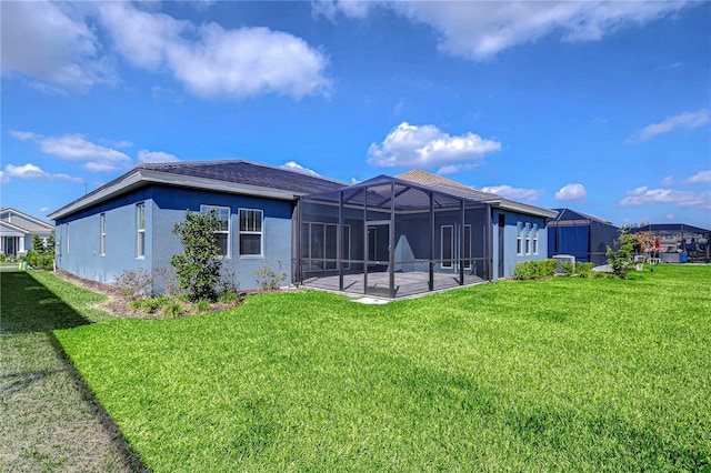 rear view of property with a yard, a lanai, and a patio