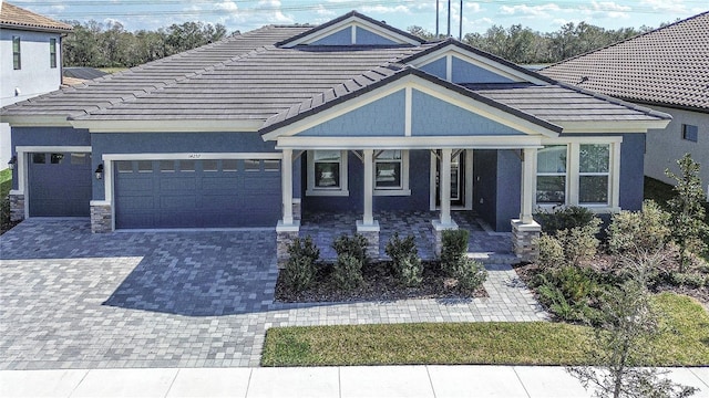 view of front facade with a garage and a porch