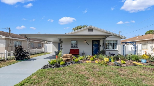 ranch-style home with a carport and a front yard