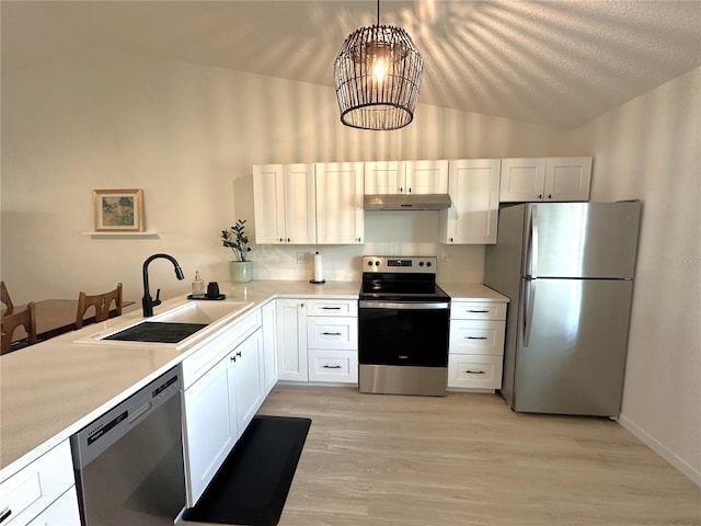 kitchen featuring appliances with stainless steel finishes, decorative light fixtures, sink, and white cabinets