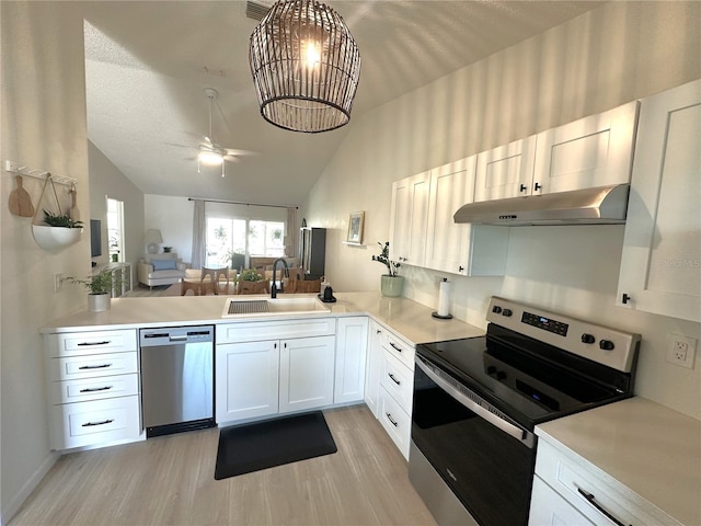 kitchen featuring white cabinetry, appliances with stainless steel finishes, sink, and light wood-type flooring