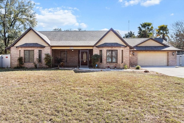 single story home featuring a garage and a front lawn