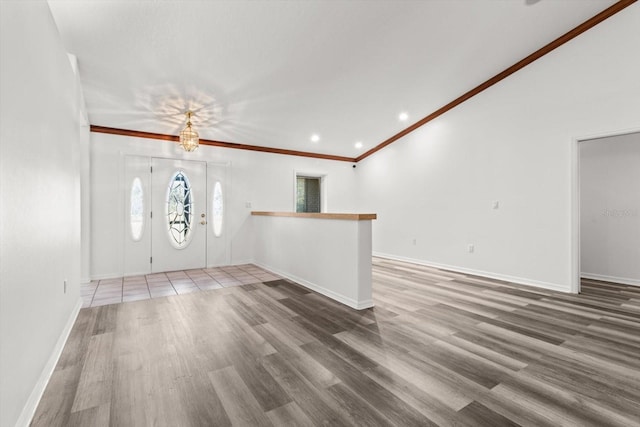 entrance foyer with hardwood / wood-style flooring and ornamental molding