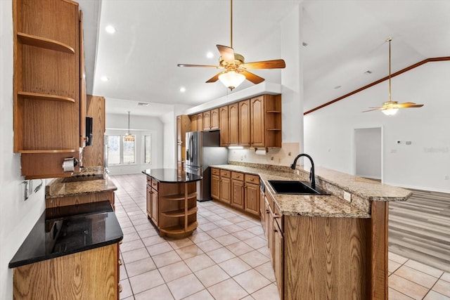 kitchen featuring light tile patterned flooring, stainless steel fridge with ice dispenser, sink, and kitchen peninsula