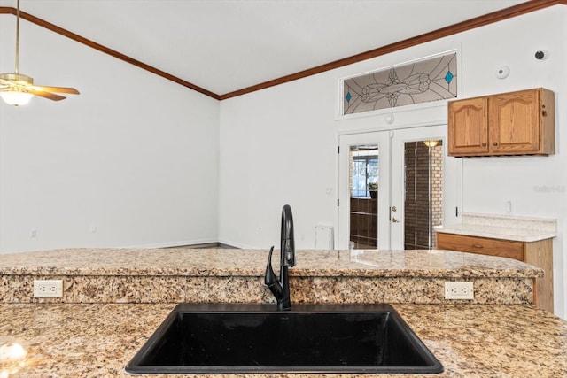 kitchen featuring french doors, sink, crown molding, vaulted ceiling, and ceiling fan