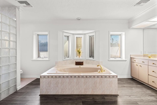 bathroom featuring ornamental molding, a wealth of natural light, vanity, and toilet