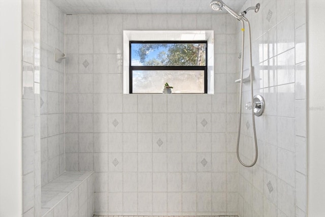 bathroom with a tile shower