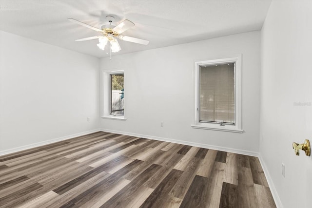 empty room with dark wood-type flooring and ceiling fan