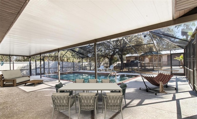 view of pool featuring glass enclosure and a patio area