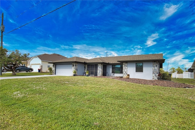 single story home featuring a garage and a front yard