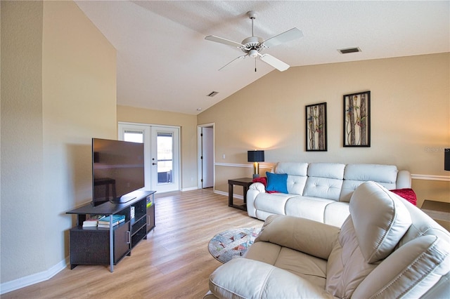 living room featuring french doors, ceiling fan, lofted ceiling, and light hardwood / wood-style floors