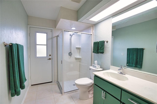 bathroom featuring vanity, tile patterned floors, toilet, and walk in shower