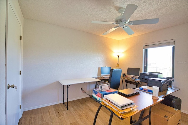 home office featuring ceiling fan, a textured ceiling, and light hardwood / wood-style floors