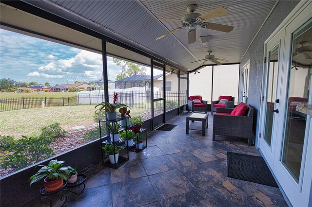 sunroom featuring ceiling fan