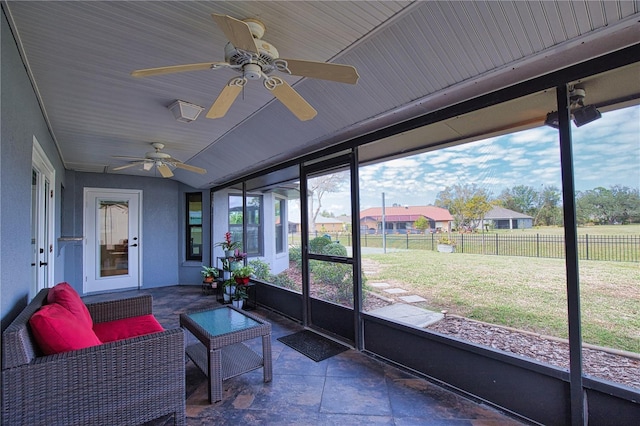 sunroom / solarium featuring ceiling fan