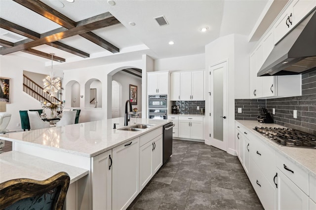 kitchen featuring white cabinetry, sink, a center island with sink, and beam ceiling