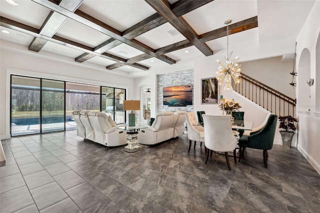 living room featuring an inviting chandelier, coffered ceiling, and beam ceiling