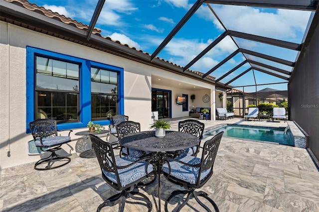 view of swimming pool featuring a patio and a lanai