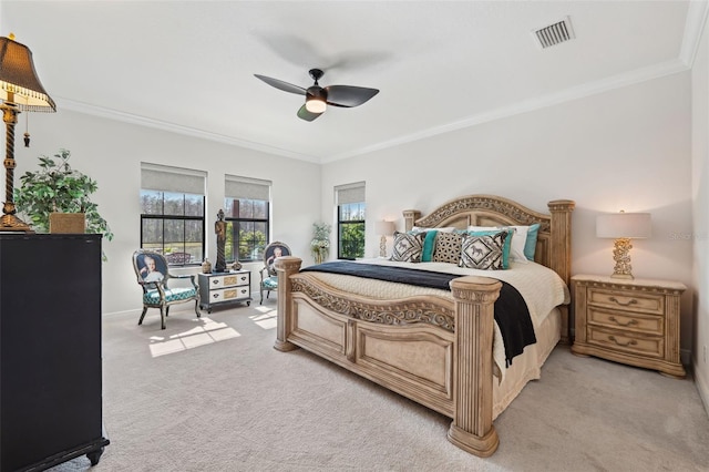 carpeted bedroom with ornamental molding and ceiling fan