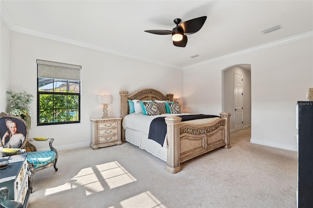 carpeted bedroom with crown molding and ceiling fan