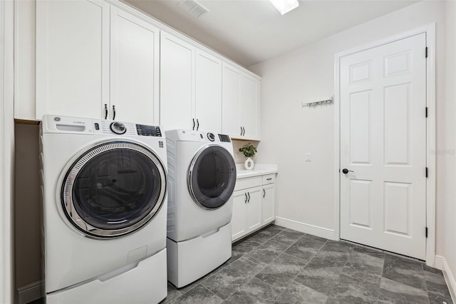 laundry room featuring cabinets and independent washer and dryer