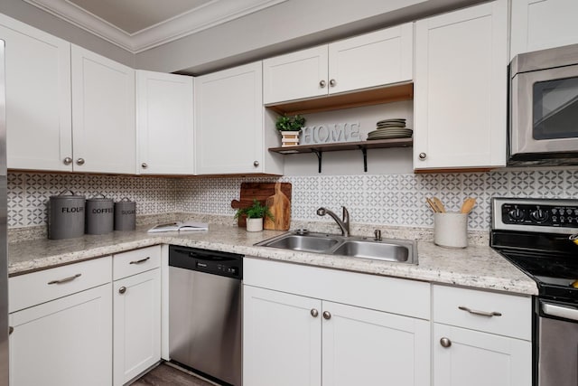 kitchen featuring white cabinetry, sink, ornamental molding, and stainless steel appliances