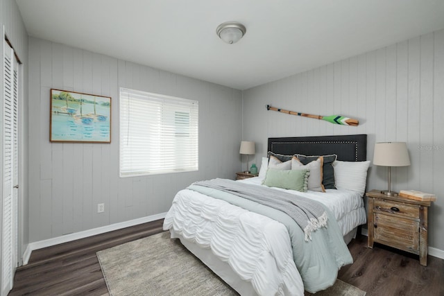 bedroom with dark hardwood / wood-style flooring