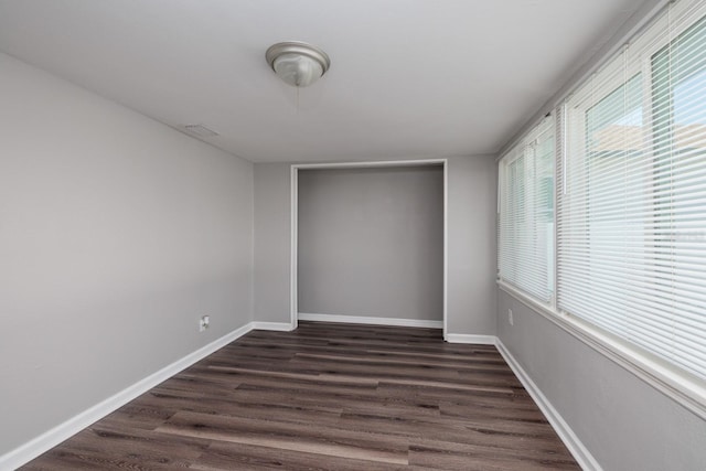 spare room with dark hardwood / wood-style floors