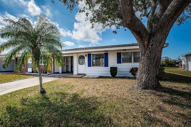 ranch-style home featuring a front yard