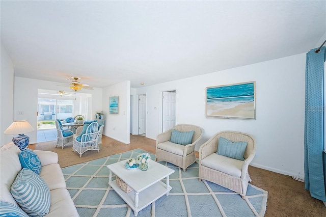 carpeted living room with ceiling fan