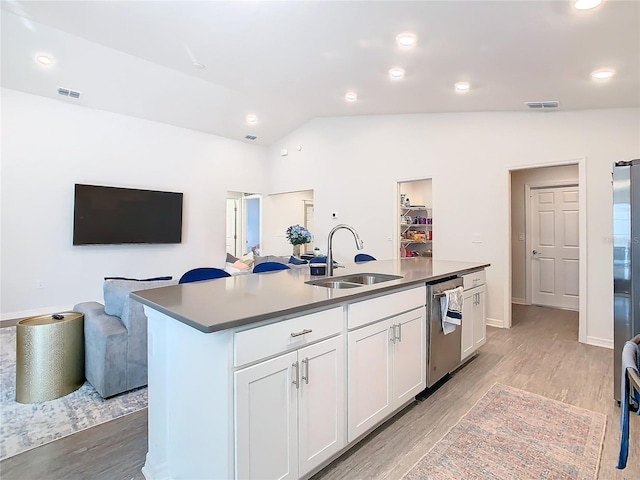 kitchen with visible vents, light wood-style flooring, open floor plan, a sink, and dishwasher
