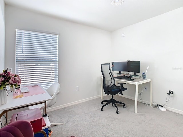 carpeted home office with baseboards