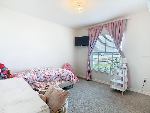 bedroom with baseboards and light colored carpet