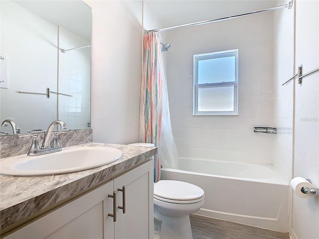 bathroom featuring shower / bath combo, vanity, toilet, and wood finished floors