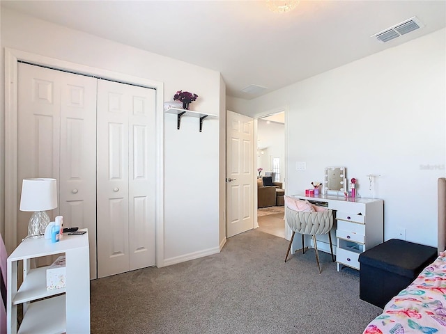 bedroom featuring a closet, visible vents, and light carpet
